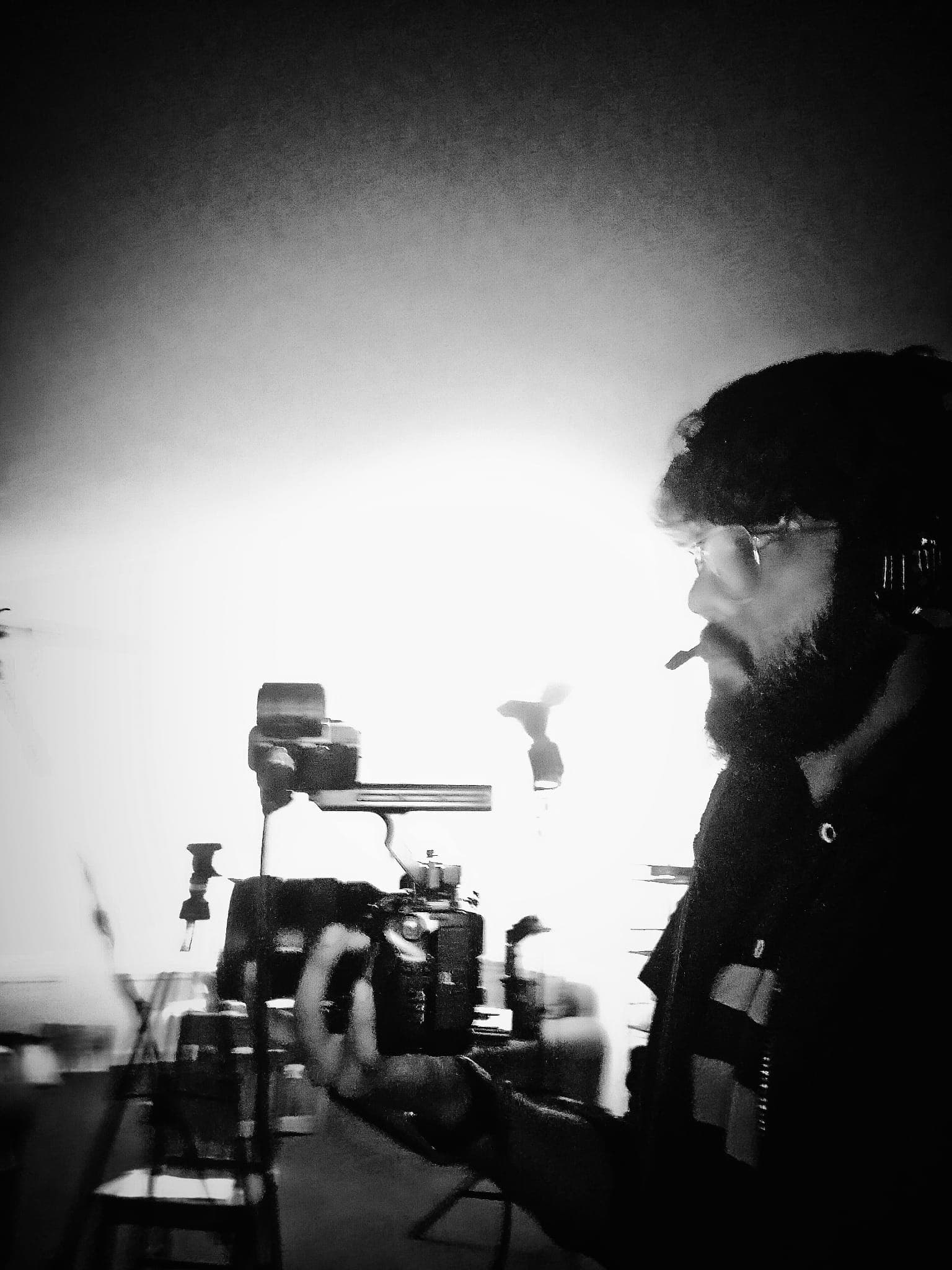 Ankit behind a Sony FX3A on set, wearing headphones